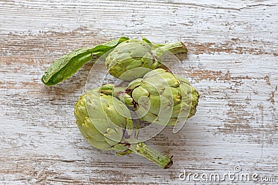 Artichoke on a rustic plank Stock Photo