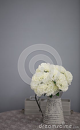 Artificail flowers in grey vase Stock Photo