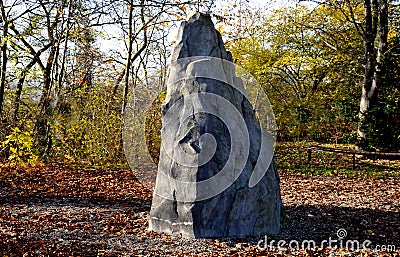 Artificial boulder in shape of an alpine mountain or dragon tooth. used to train climbers in a city park. The top stone is made of Stock Photo