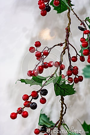 Artificial branch with red berries on a white background Stock Photo