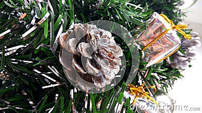 Artificial Christmas tree brunches decorated with silver baubles, toy gift boxes and cone. New Year holiday decorati Stock Photo