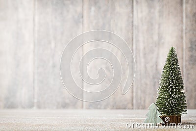 Artificial Christmas tree on a wooden background. Stock Photo