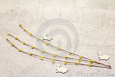 Artificial decorative willow twigs and wooden figures of bunny. The concept of Easter cards, wallpapers, stone background. Copy Stock Photo