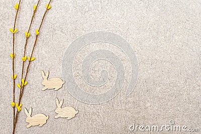 Artificial decorative willow twigs and wooden figures of bunny. The concept of Easter cards, wallpapers, stone background. Top Stock Photo