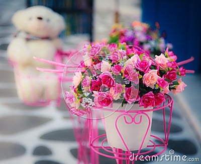 Artificial flower in vase with blurry doll in the Stock Photo