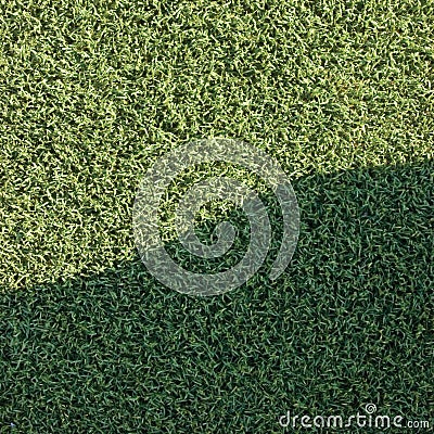 Artificial grass fake turf synthetic lawn field macro closeup with gentle shaded shadow area, green sports texture background Stock Photo