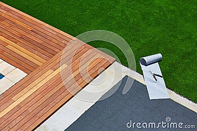 Artificial grass installation in deck garden with tools Stock Photo