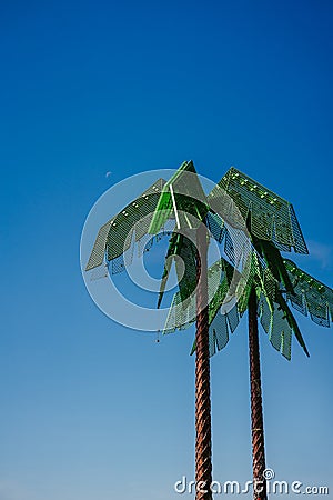 Artificial green metal palms with blue sky background in Park Fiction Hamburg. An artistic and sociopolitical project Stock Photo