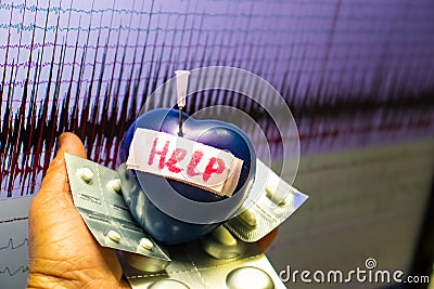 Artificial heart stung by needle . Stock Photo