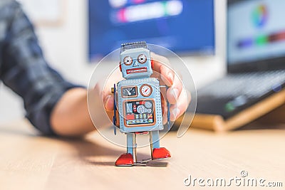 Artificial intelligence concept: Toy robot on office desktop. Metaphor for chatbot, social bot and algorithms Stock Photo