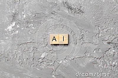 Artificial Intelligence word written on wood block. AI text on cement table for your desing, concept Stock Photo