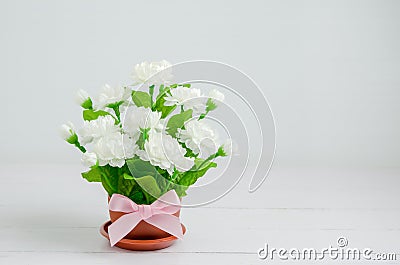 Artificial Jasmine flower bouquet with pink ribbon bow Stock Photo