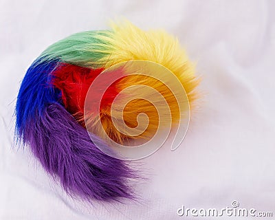 Artificial Rainbow fur skin closeup. Coiled up on white background Stock Photo