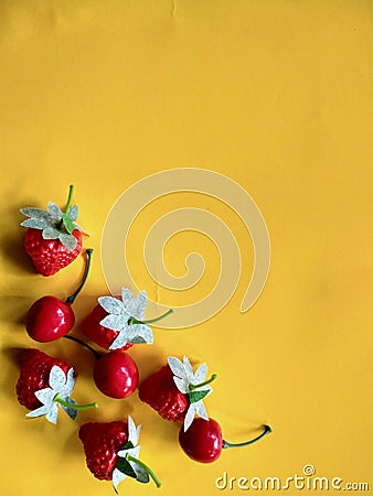 Artificial strawberries and cherries fruit isolated on orange background. Free copy space Stock Photo