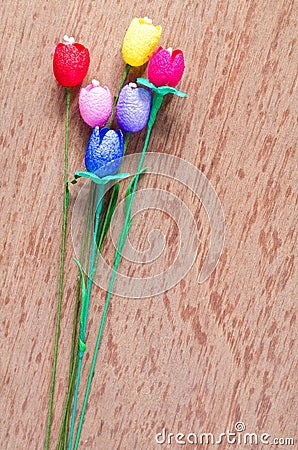 Artificial tulips flower made from silk cocoon on plywo Stock Photo