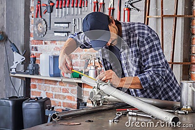 Artisan; component; engineering; man; manufacturing; metal; metalworker; occupation; pipe; production; trade; workshop; worker; Stock Photo