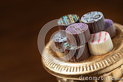 Artisan Fine Chocolate Candy On Gold Pillar Serving Dish Stock Photo