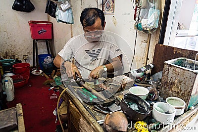 Siem Reap, Cambodia - December 15, 2018. Local Artisan works in a market Editorial Stock Photo