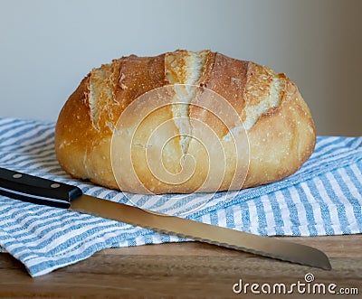 Artisan homemade crusty bread Boule loaf on cutting board Stock Photo