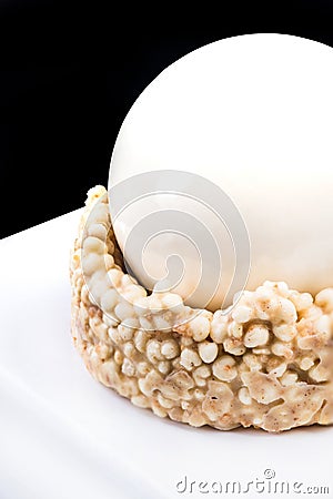 Artisan Monoportion Patisserie Dessert Cake on Whitte Reflective Background Stock Photo