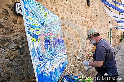 The artist Alexander Sorokin and Svetlana Sherbina paints a picture on the street Editorial Stock Photo