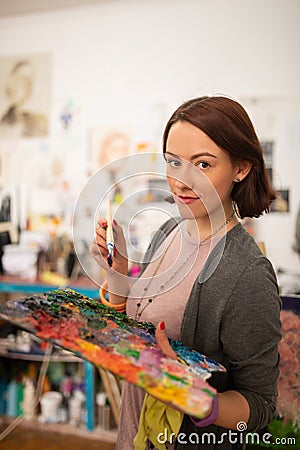 Artist with bob cut holding color palette and brush Stock Photo
