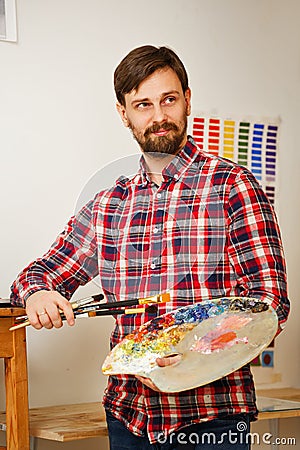 Artist with brushes and palette Stock Photo