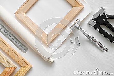 Artist canvas in roll, wooden stretcher bars, canvas stretcher pilers and staple gun. Stock Photo