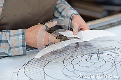 Artist cutting tracing paper template Stock Photo