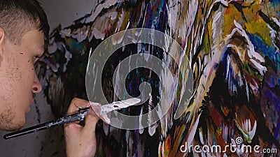 Artist designer draws an eagle on the wall. Craftsman decorator paints picture with acrylic oil color. Painter painter Stock Photo