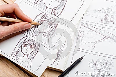 Artist drawing an anime comic book in a studio Stock Photo