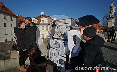 Artist at work at the historic Charles Bridge in Prague, Czech Republic Editorial Stock Photo