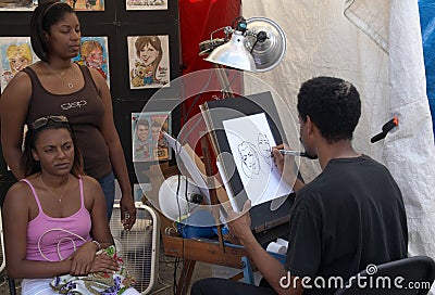 An artist drawing two women Editorial Stock Photo