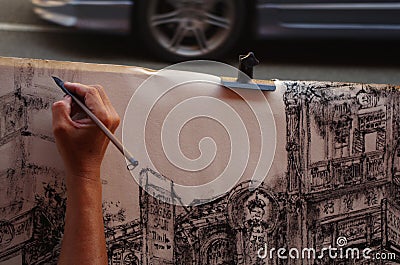 Artist draws a glimpse of the city with a pencil Editorial Stock Photo