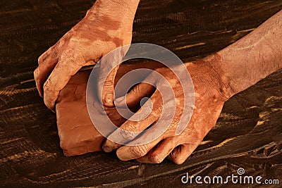 Artist man hands working red clay for handcraft Stock Photo