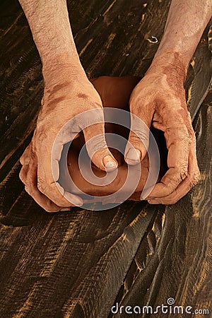 Artist man hands working red clay for handcraft Stock Photo