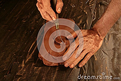 Artist man hands working red clay for handcraft Stock Photo