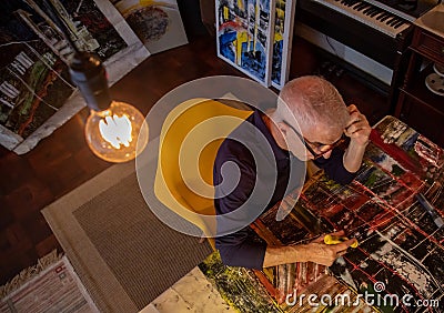 Artist middle-aged man painting or drawing digitally Stock Photo