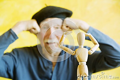 Artist Mimics a Wooden Figure Stock Photo