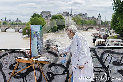 Artist painting by the seine river Editorial Stock Photo