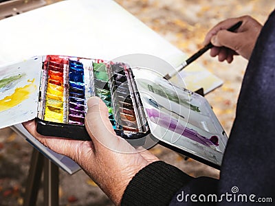 Artist painting watercolours People Leisure lifestyle outdoor Stock Photo