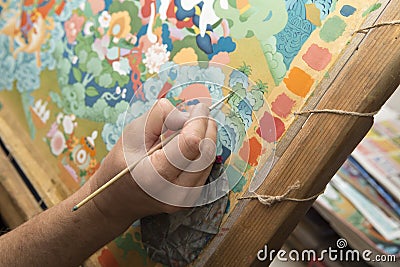 The artist paints a Buddhist icon Stock Photo