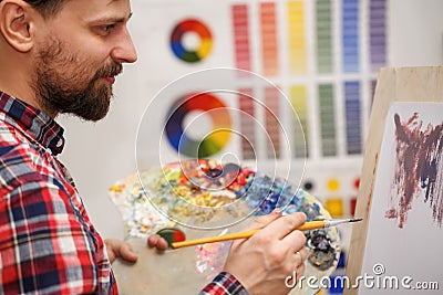 Artist paints with oil paints Stock Photo