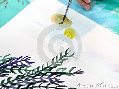 Artist paints picture with brush with watercolors Stock Photo