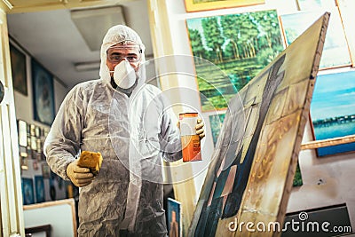 The artist restores the painting Stock Photo