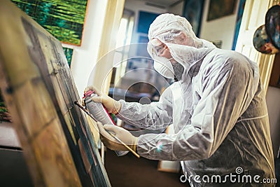 The artist restores the painting Stock Photo