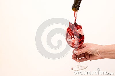 Artistic beautiful picture. Red wine is poured into a glass Stock Photo