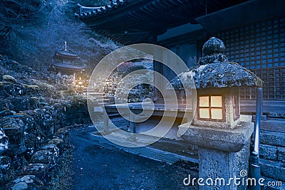 Artistic edit of lamps burning at night in the area of ancient Otagi Nenbutsu-ji Buddhist temple in Kyoto, Japan Stock Photo