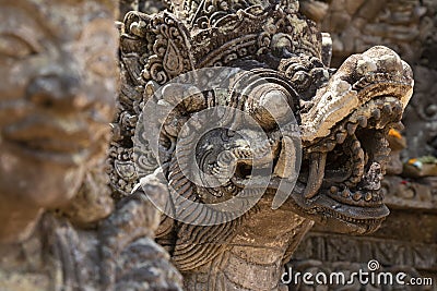 Artistic figure sculpted in stone of a mythological being, in a Hindu temple, Bali, Indonesia Stock Photo