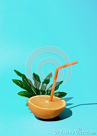 Orange that gives fresh juice to a straw Stock Photo